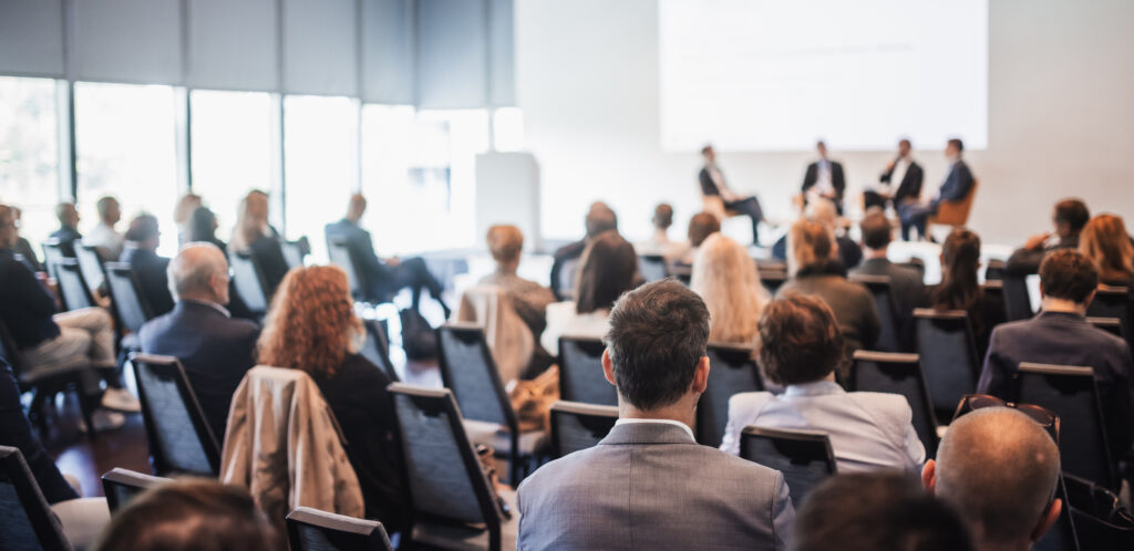 Interview and round table discussion at business convention and presentation. Audience at the conference hall. Business and entrepreneurship symposium